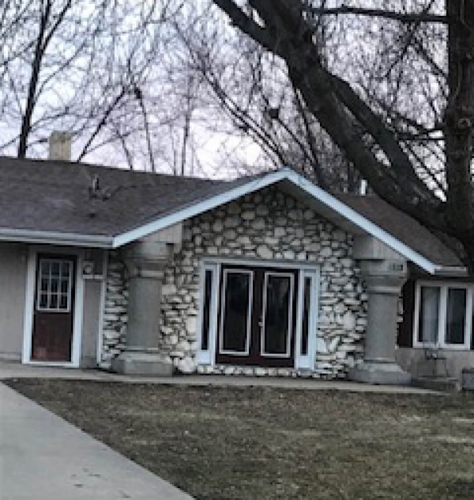 Exterior of 1215 C Avenue West home in Oskaloosa, Iowa, featuring the Mahaska County Courthouse columns.